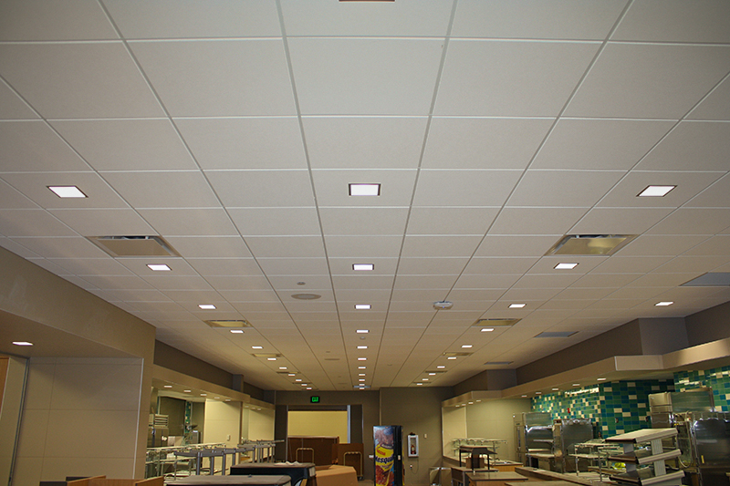 Traditional accoustical ceiling tiles installed in the cafeteria of a school